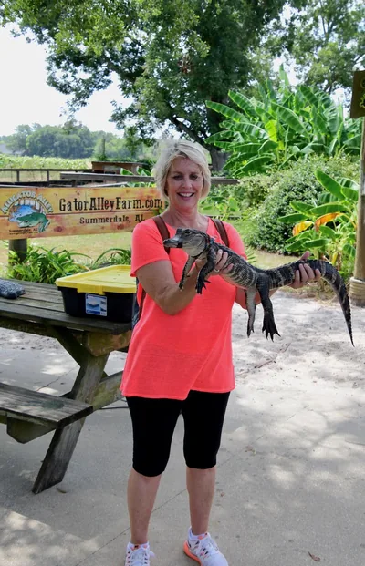 Holding a young alligator